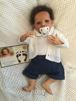 Beautiful black, mixed race reborn baby boy doll. Hand rooted hair. 19 ins