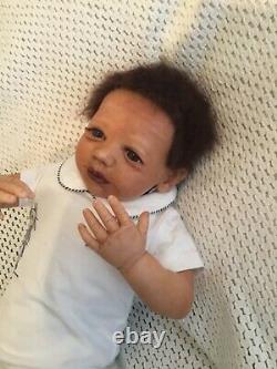 Beautiful black, mixed race reborn baby boy doll. Hand rooted hair. 19 ins