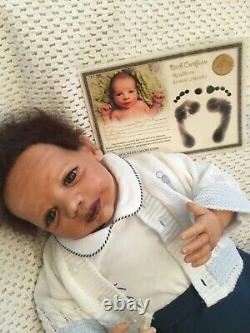 Beautiful black, mixed race reborn baby boy doll. Hand rooted hair. 19 ins