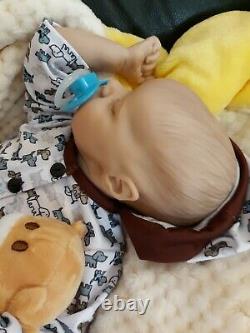 Reborn BABY 16 In takes a baby pacifier