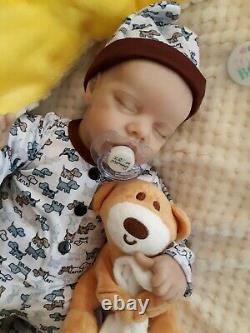 Reborn BABY 16 In takes a baby pacifier