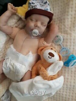 Reborn BABY 16 In takes a baby pacifier